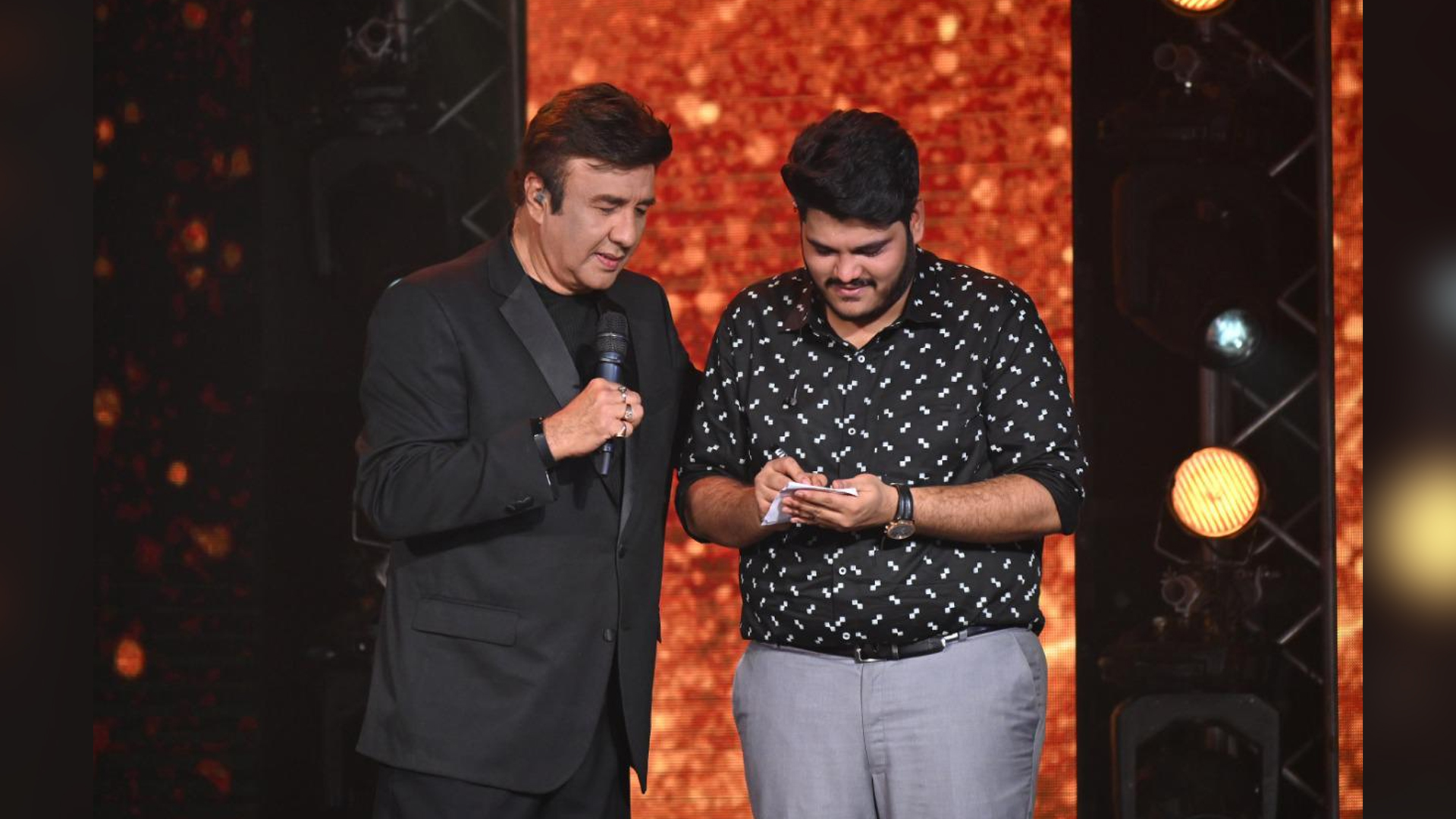 Anu Malik receives an autograph from the talented singer Ashish Kulkarni on the sets of Indian Idol 12.